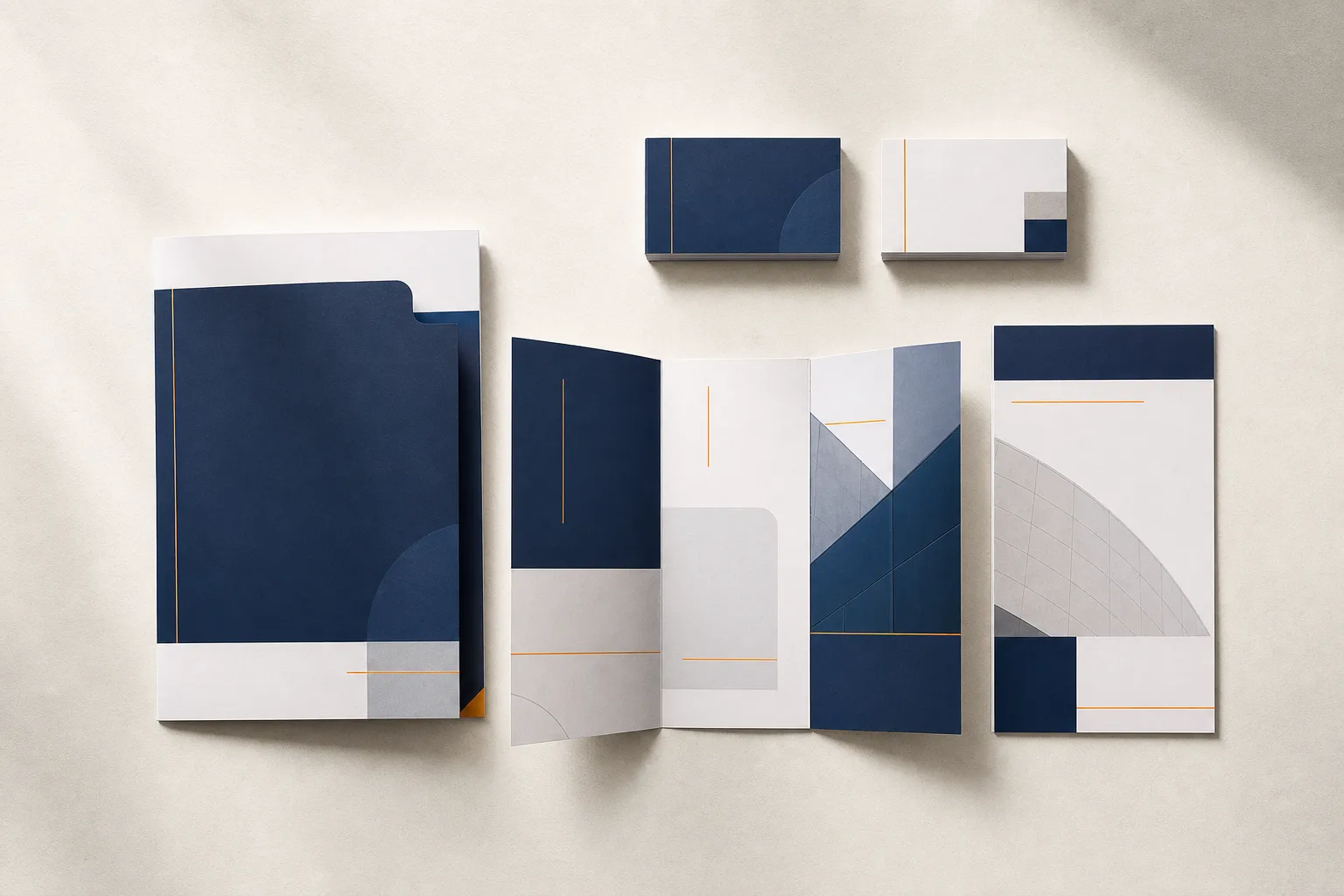 Coordinated printed business cards, brochures, flyers, and presentation folders in navy and amber.